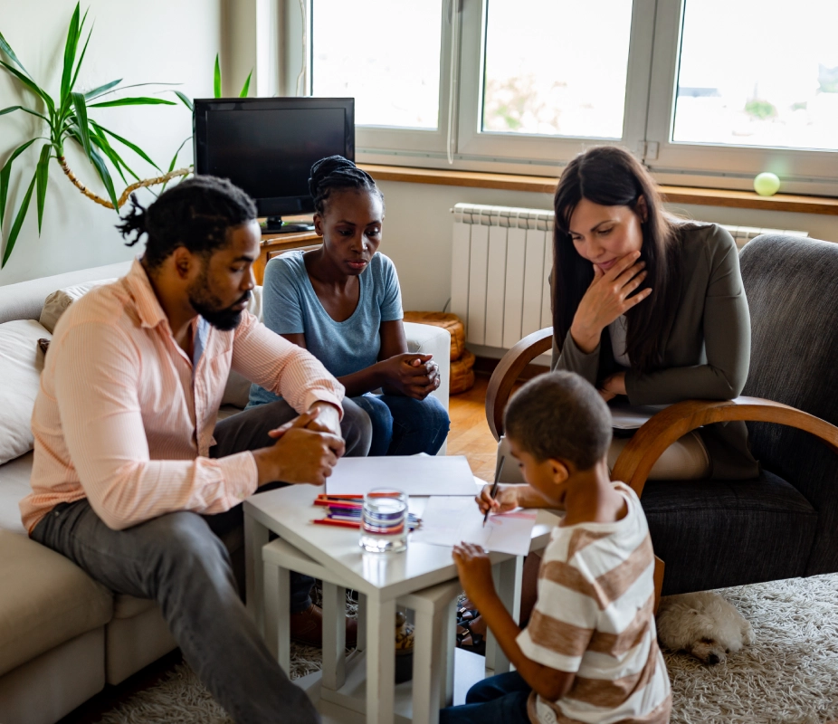 Family meeting with counselor in living room.