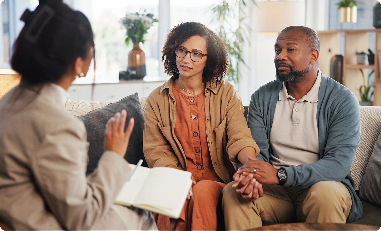 Couple in therapy session with therapist.